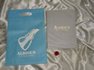 Aldious ブックカバー付き15年記念ヒストリー&フォトブック(初版) ホログラム缶バッジ 不織布バッグ